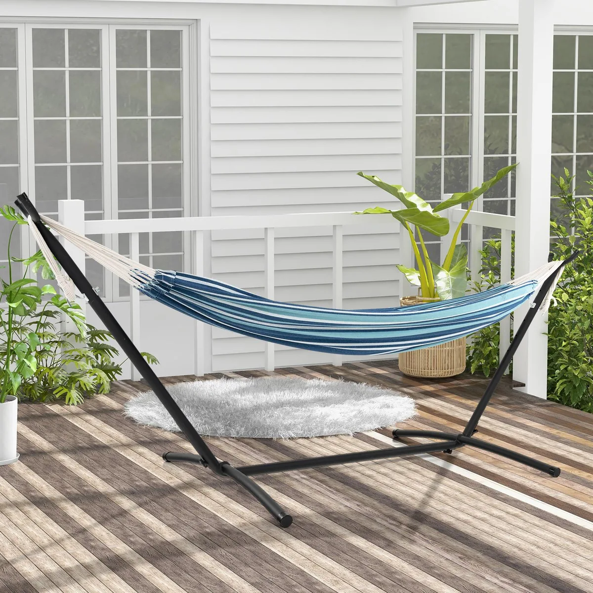 Blue double hammock on metal stand with two carry bags