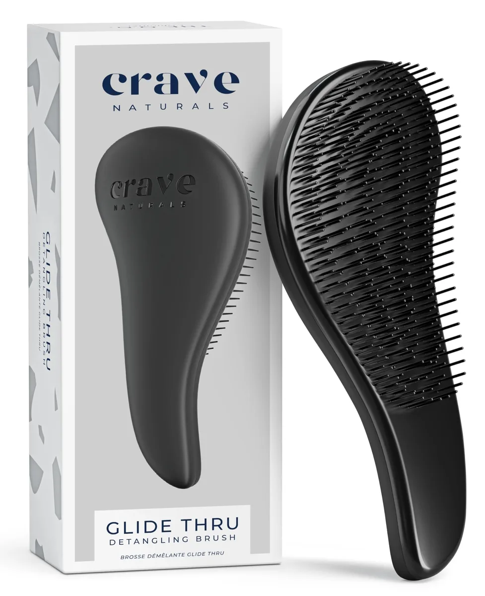 Black rectangular detangling brush with soft plastic bristles and curved handle