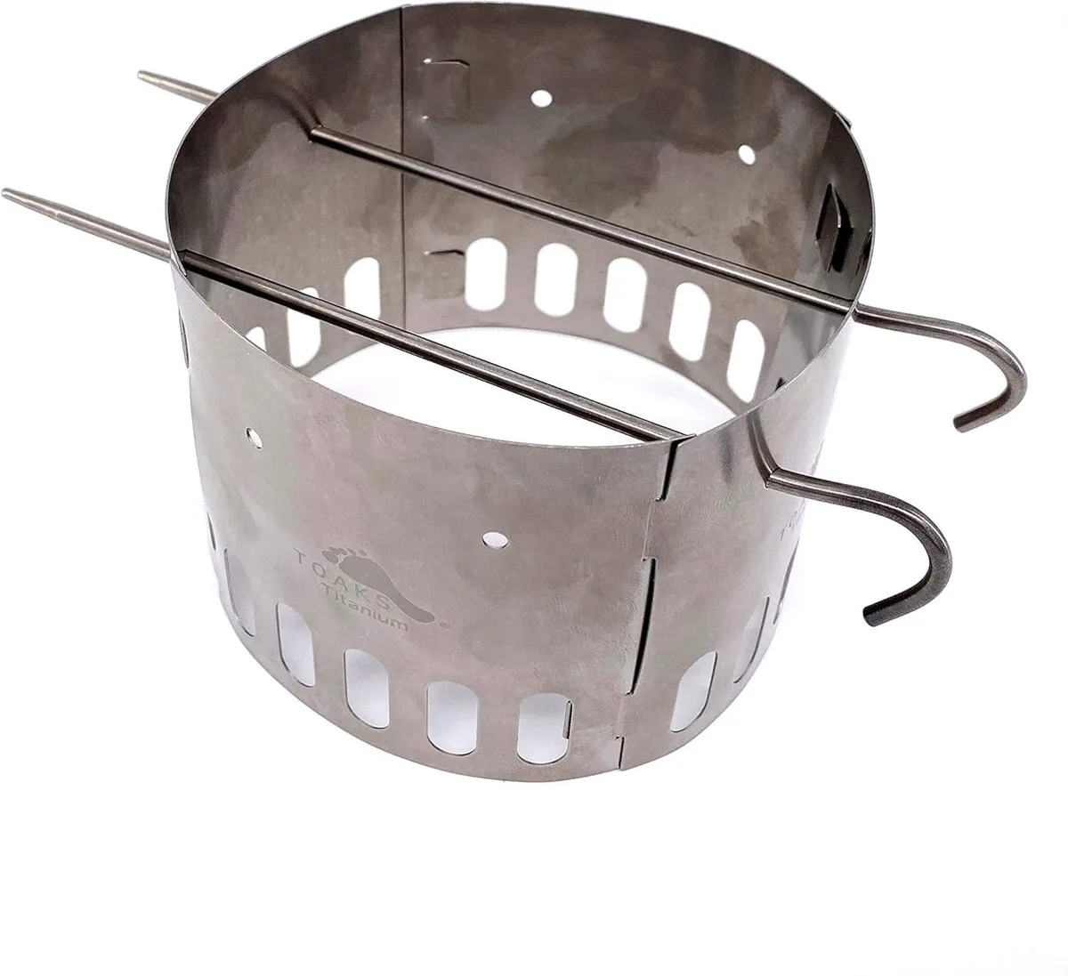 Four flat titanium panels and two stakes forming a pot stand and windscreen