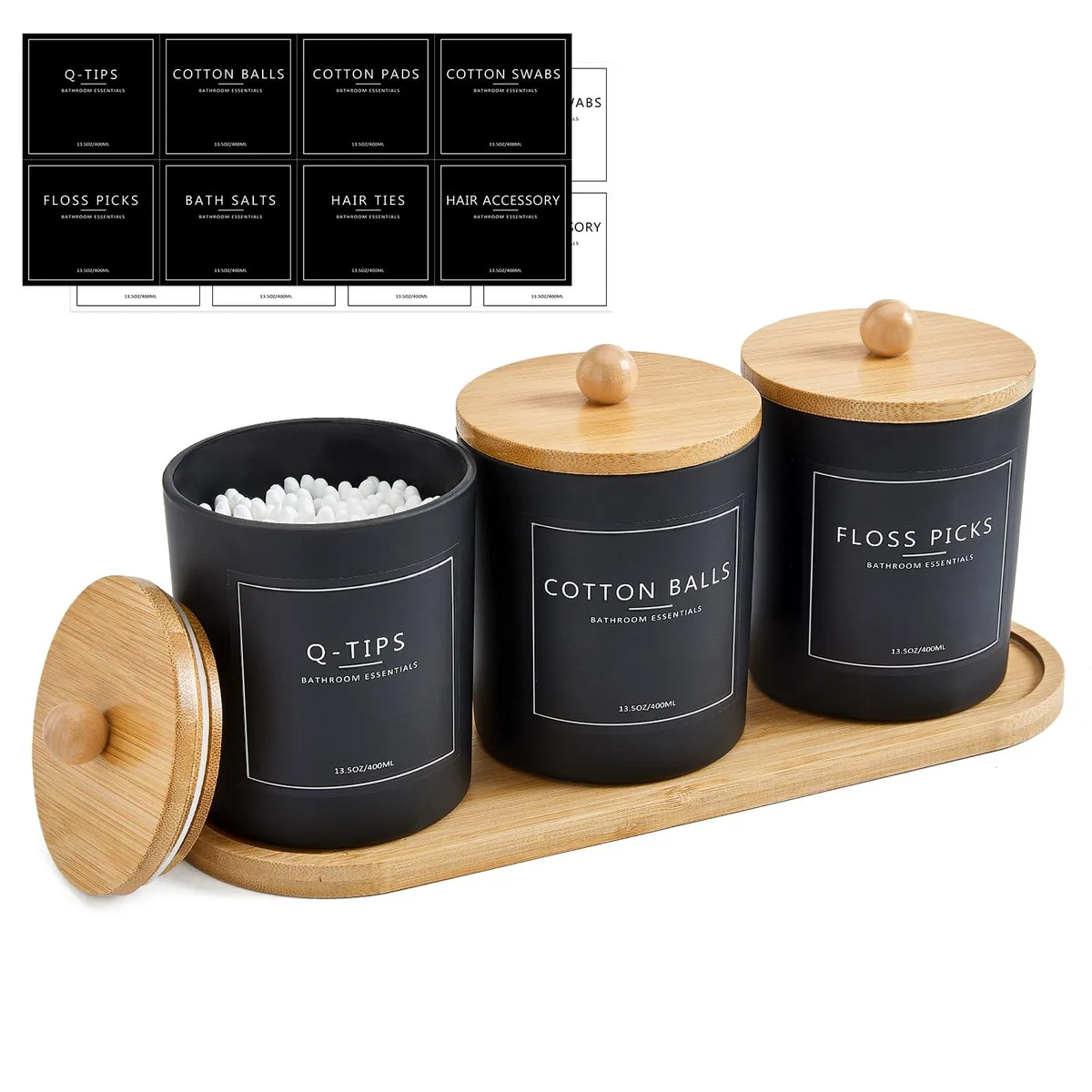 Three frosted glass jars with bamboo lids on a bamboo tray