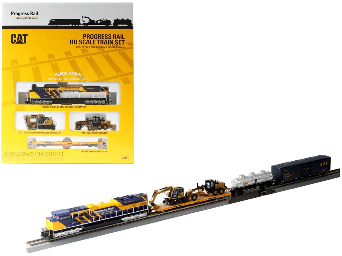 HO scale diecast train set with yellow Caterpillar locomotive, freight cars, construction vehicles and oval track