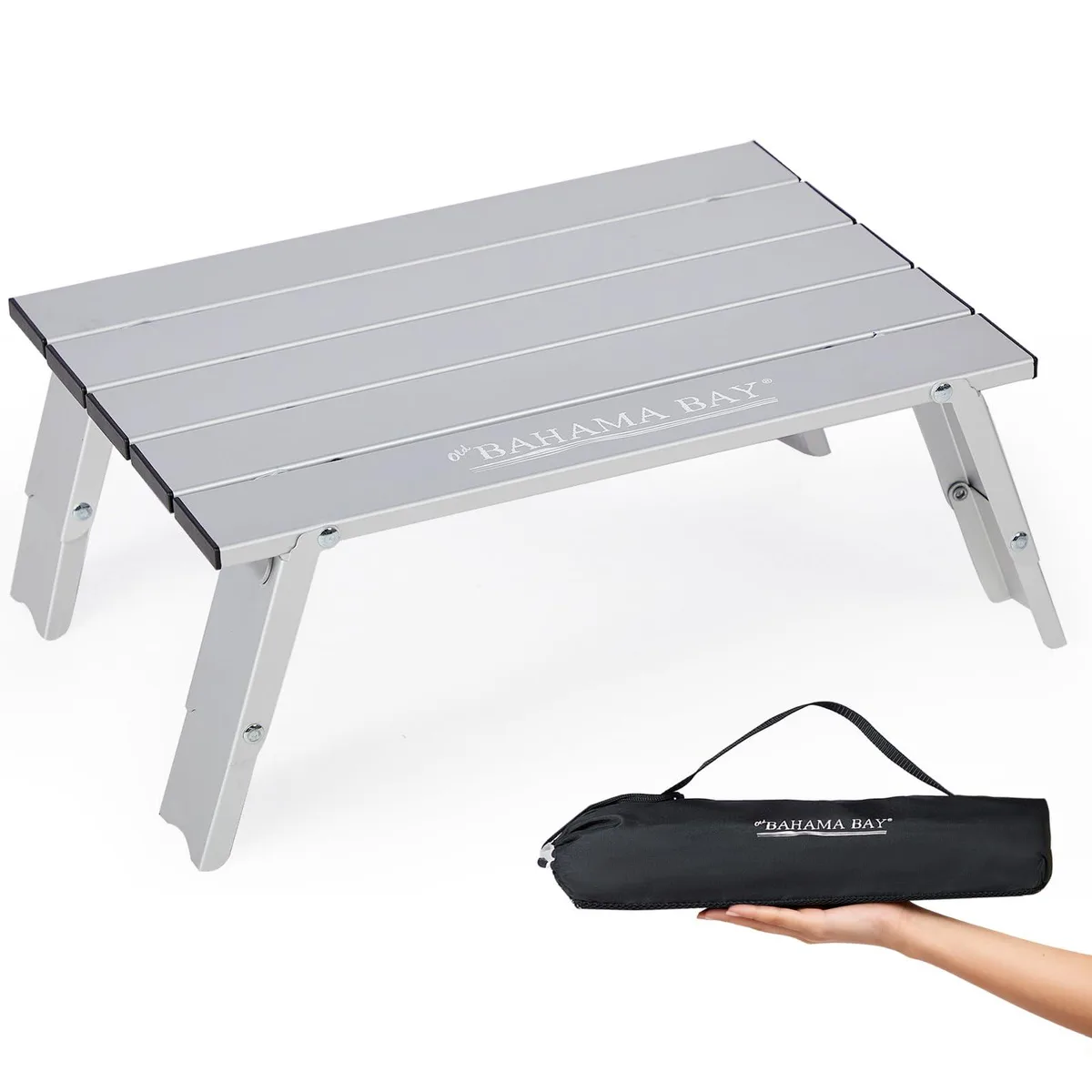 Black aluminium mini beach table folded flat with retractable legs visible