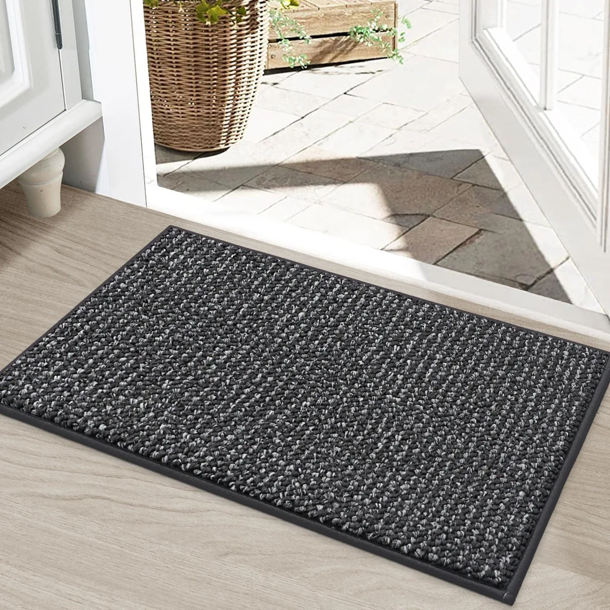 Charcoal rectangular door mat, low-profile woven surface with reinforced edges, non-slip backing visible underneath