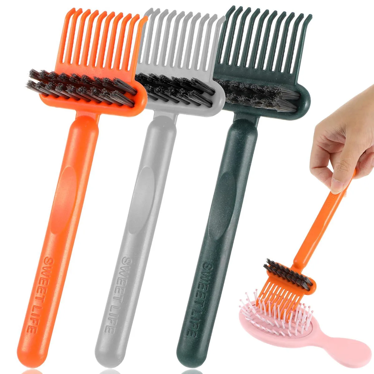 Three small plastic comb cleaners with dual bristle heads and ergonomic handles