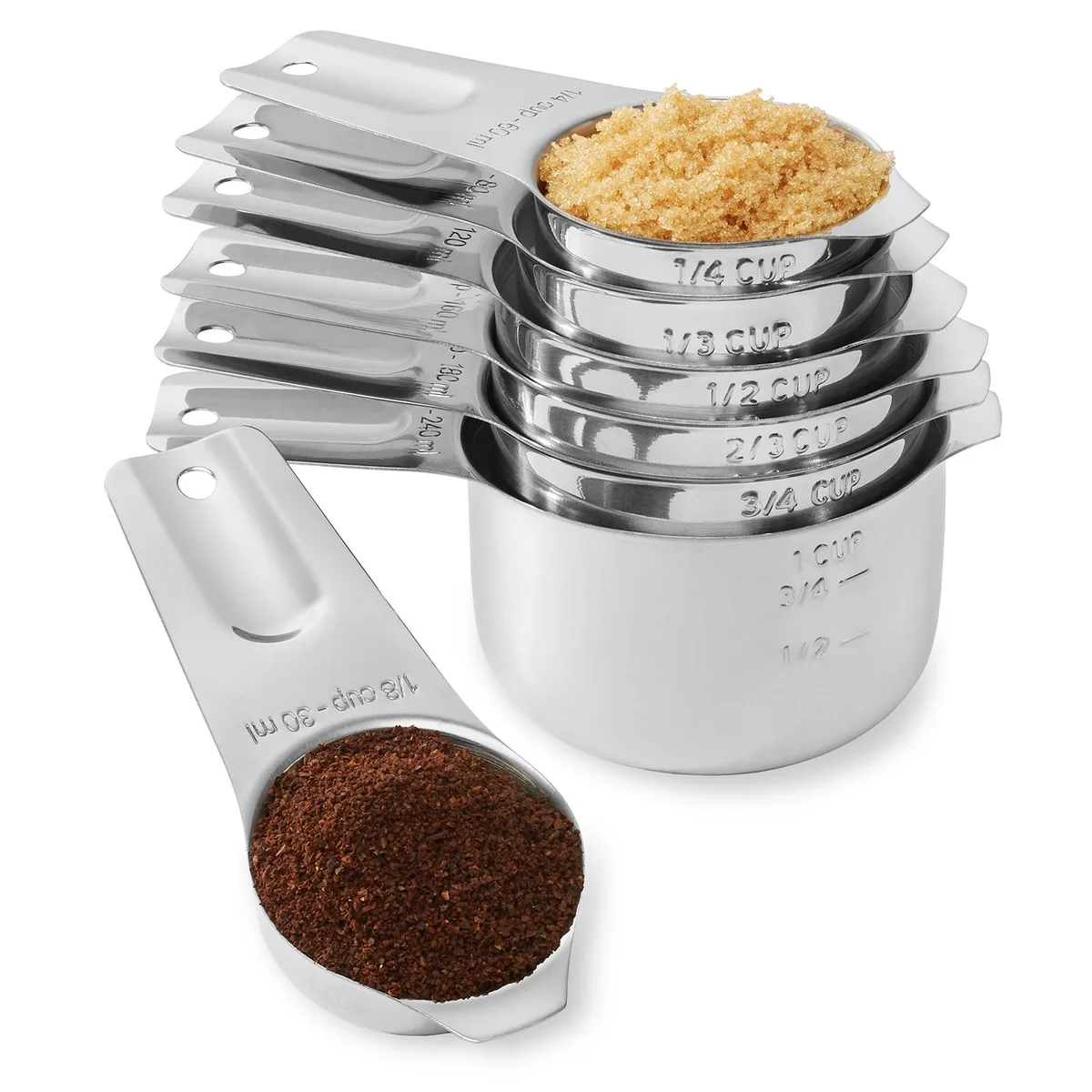 Seven stainless steel measuring cups nested together with a ring
