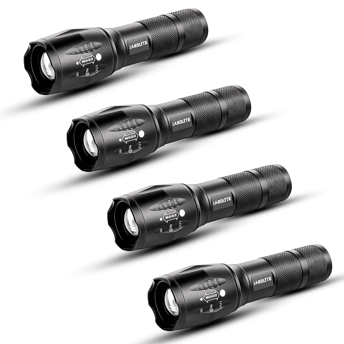 Four matte-black tactical flashlights with knurled grips and scalloped bezels lying side by side