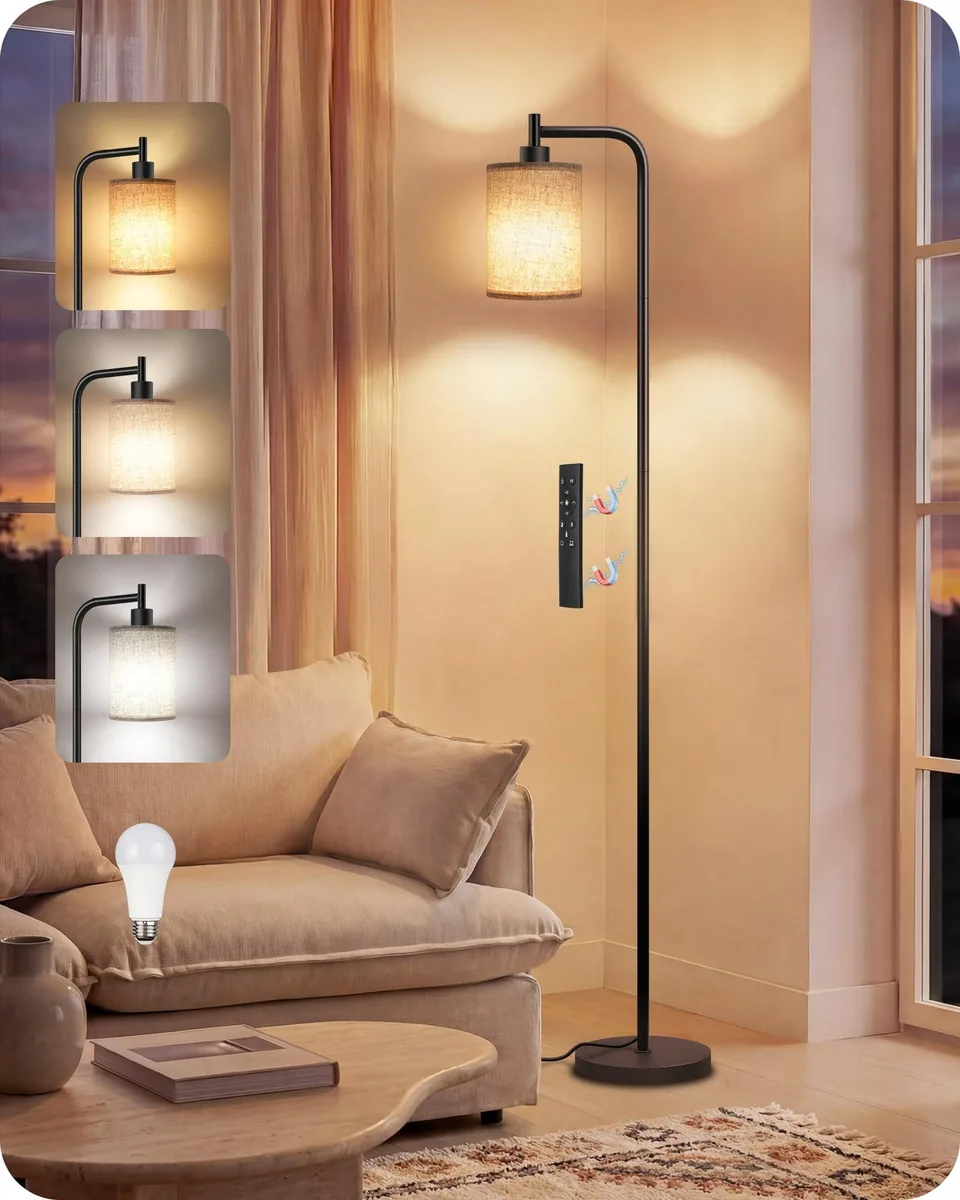 Tall floor lamp with matte black metal base, beige linen shade, remote on pole