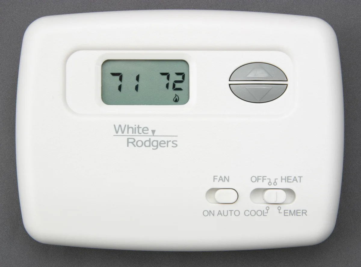 White rectangular thermostat with digital display, hardwired 24VAC