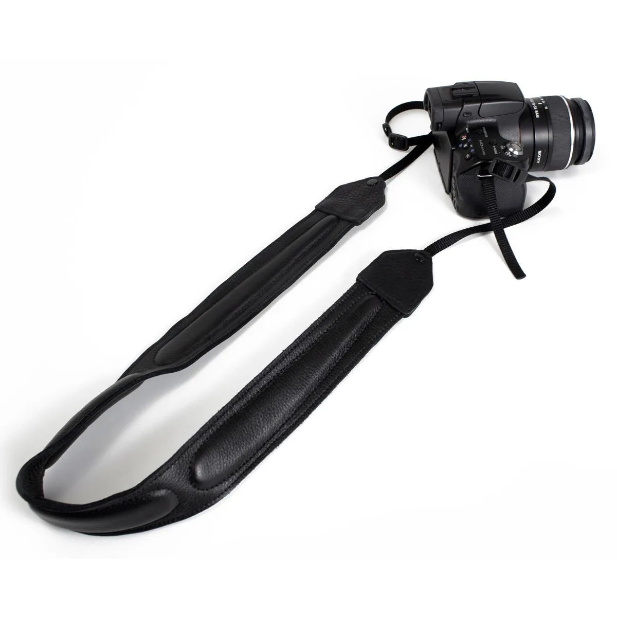Black leather camera strap with ergonomic shoulder pad, adjustable length