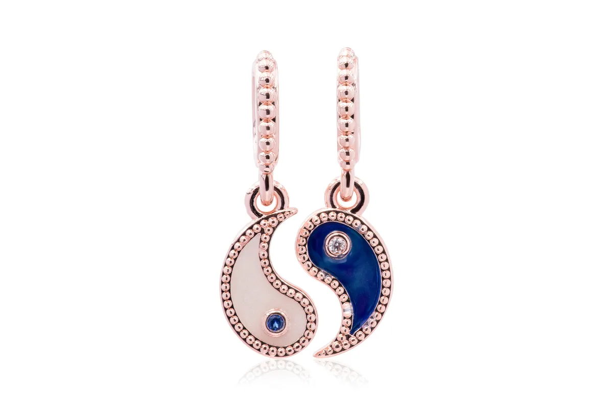 Splittable yin-yang dangle charm in silver and rose gold with white and blue enamel
