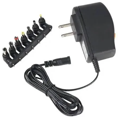 Black rectangular wall adapter with coiled cable and multiple interchangeable tips