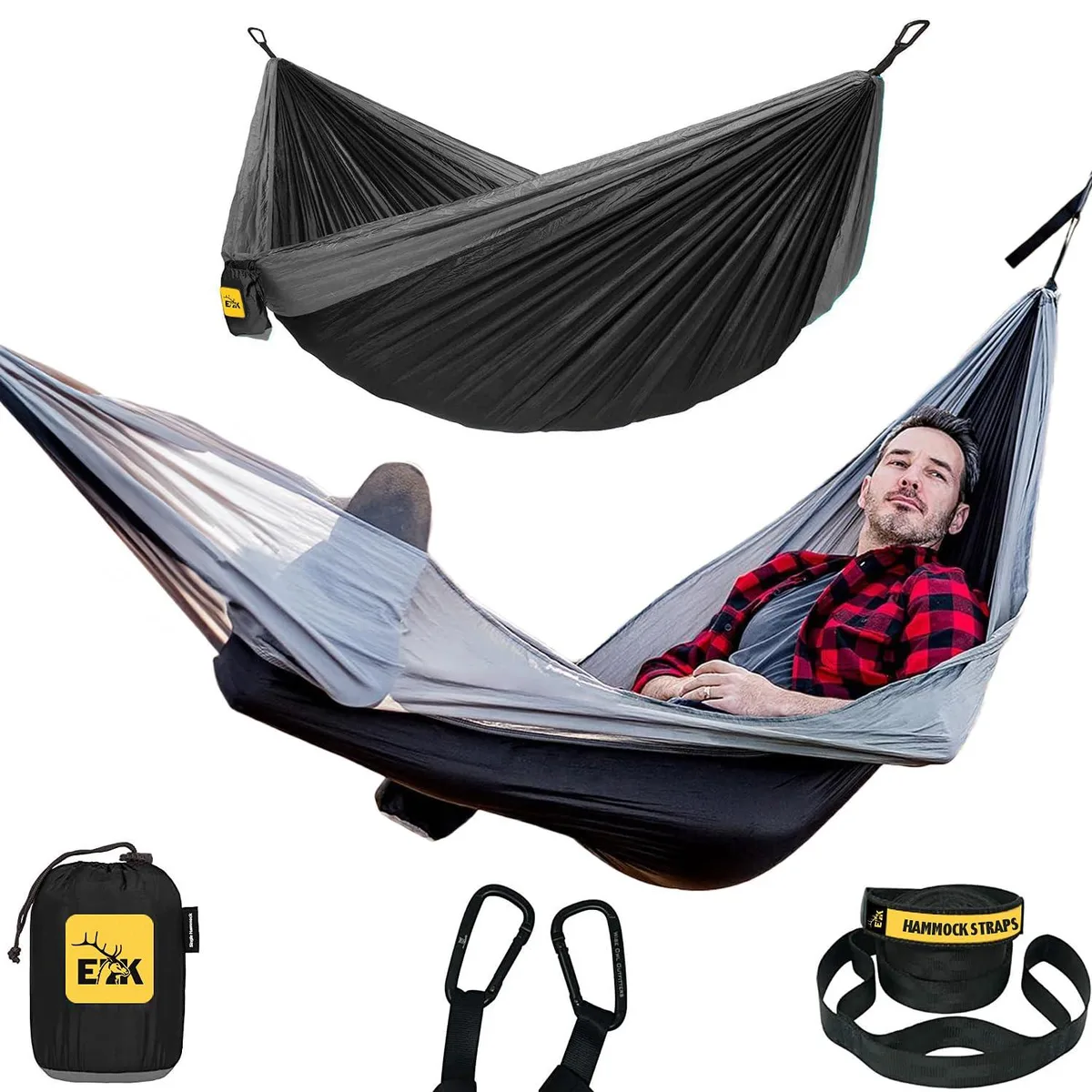 Black and grey parachute-nylon hammock with tree straps and carabiners, packed in stuff sack