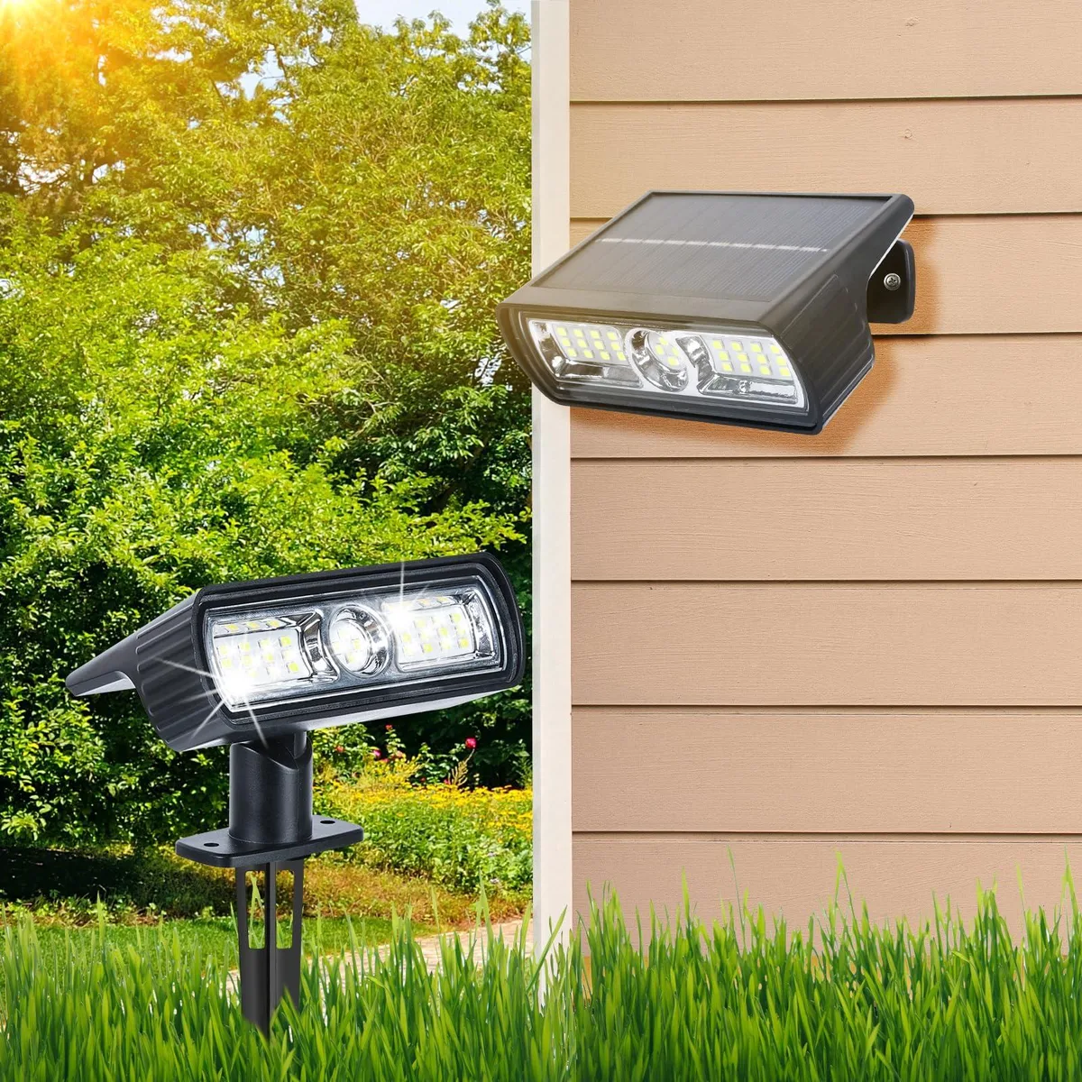 Two white plastic solar spot lights with clear prismatic lenses on ground stakes