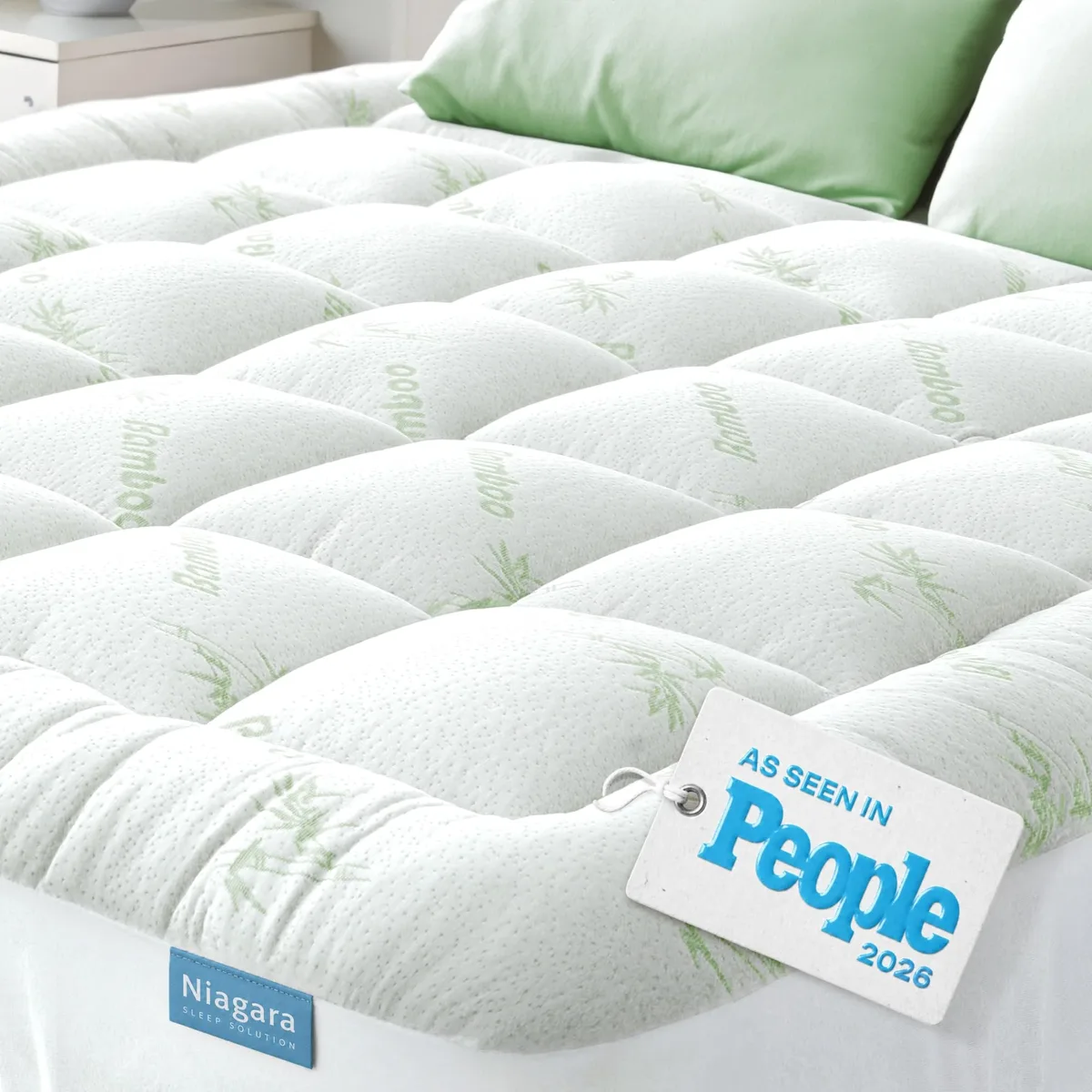 White rectangular mattress topper with deep elasticated sides and quilted bamboo surface