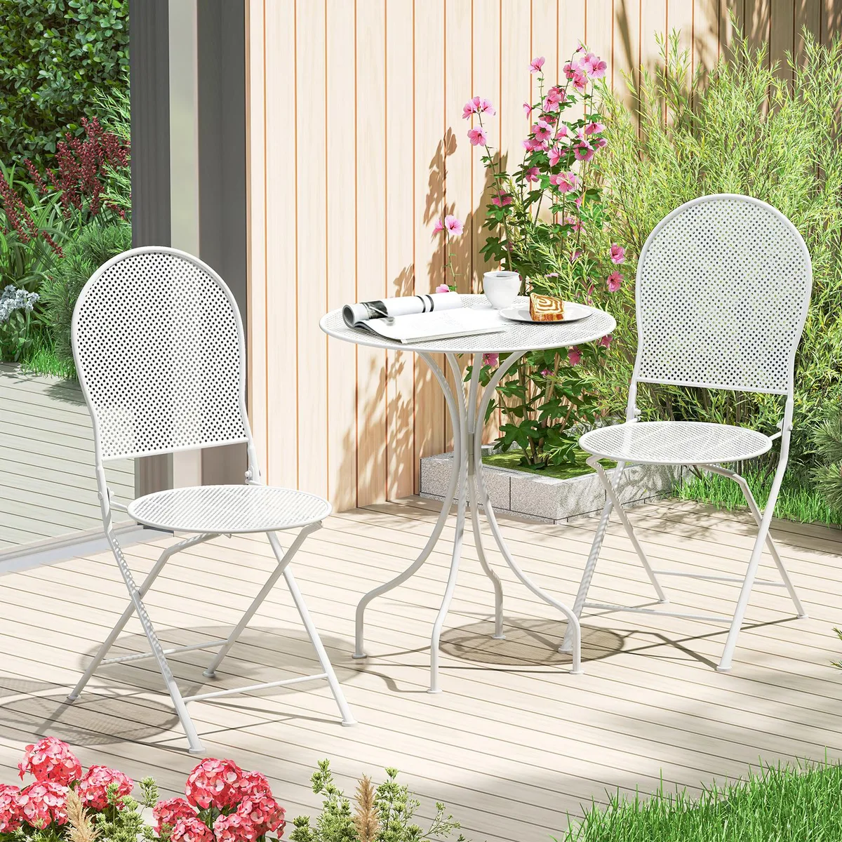 White metal bistro set with round table and two folding chairs