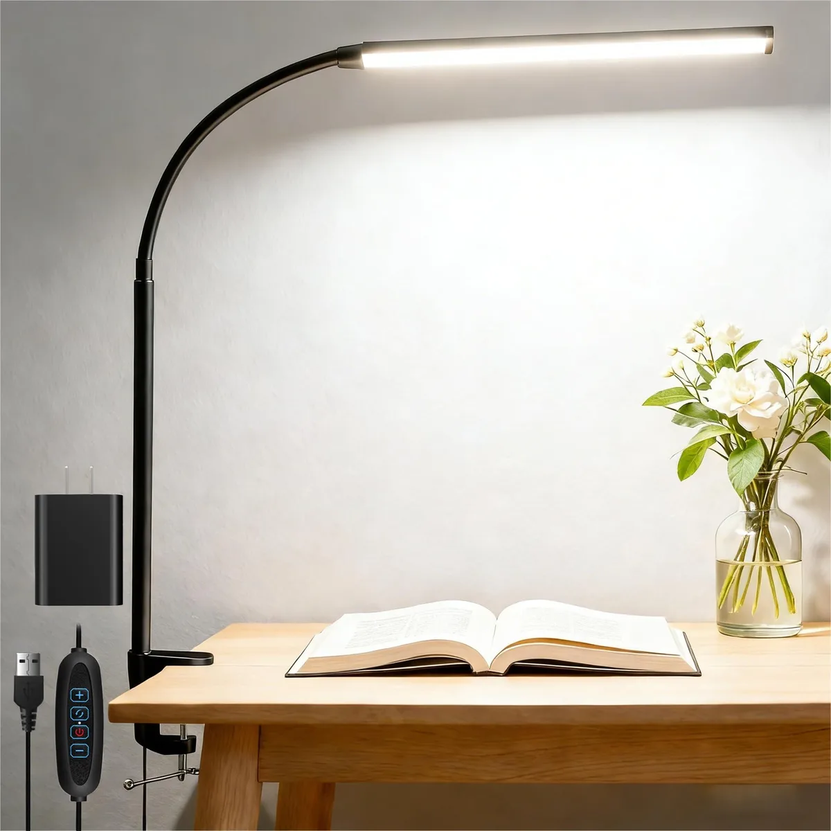 An L-shaped painted desk lamp with a flexible gooseneck and C-clamp base