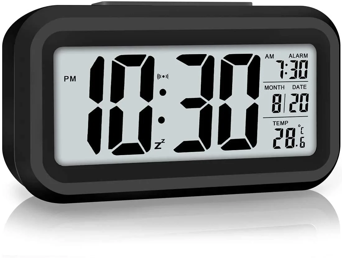 Rectangular digital alarm clock with large 4.5 inch LCD display showing time temperature and calendar in dark plastic case