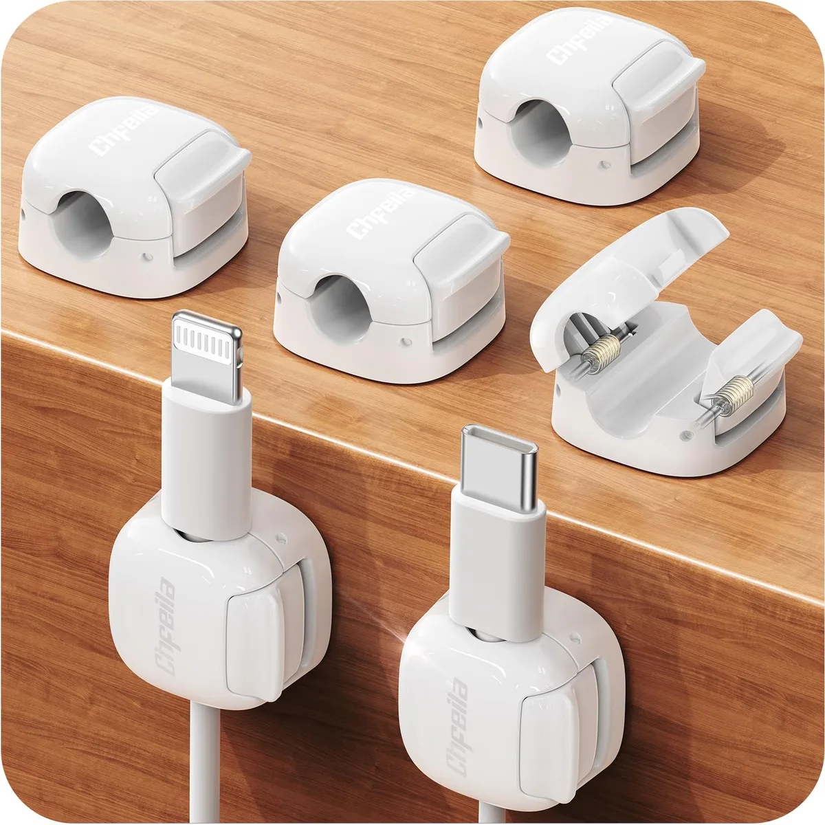 Six small white square cord clips with adhesive backs