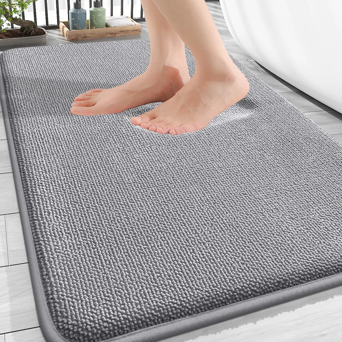 Rectangular grey memory foam bath mat with soft velvet surface and non-slip backing