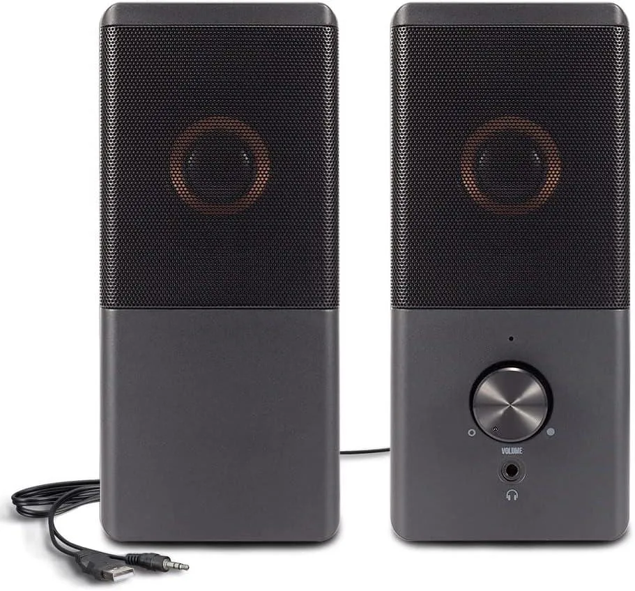 Two compact rectangular speakers in dark finish with front volume knob and headphone jack