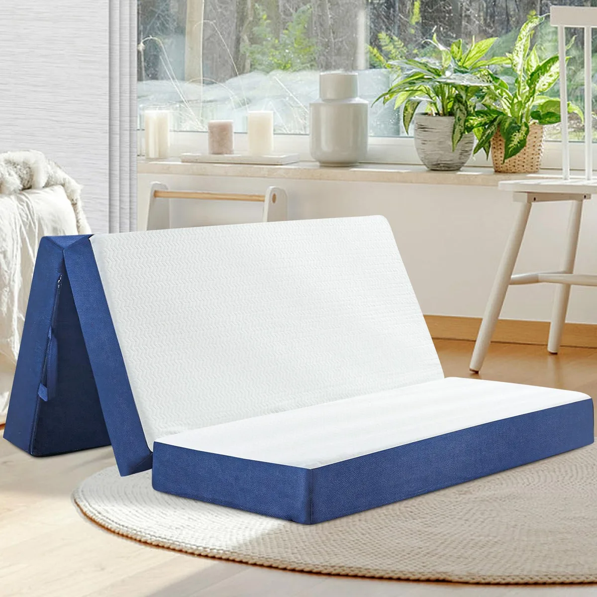 White trifold foam mattress folded into a compact rectangle with carry handle