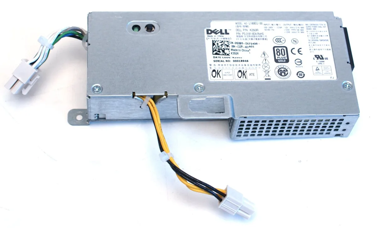 Small rectangular silver metal power supply unit with ventilation slots and label