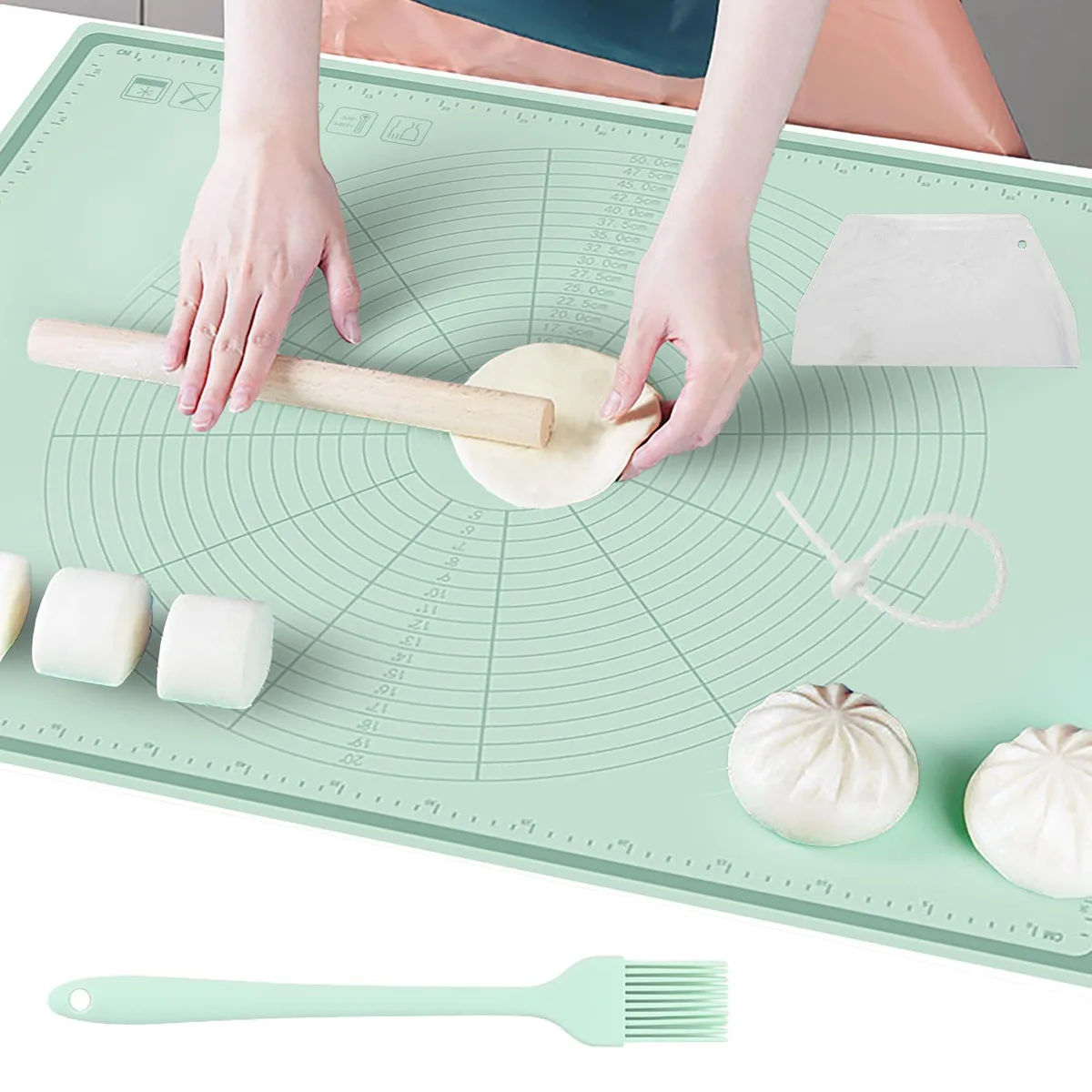 Green rectangular silicone baking mat with raised edges and embossed measurement markings