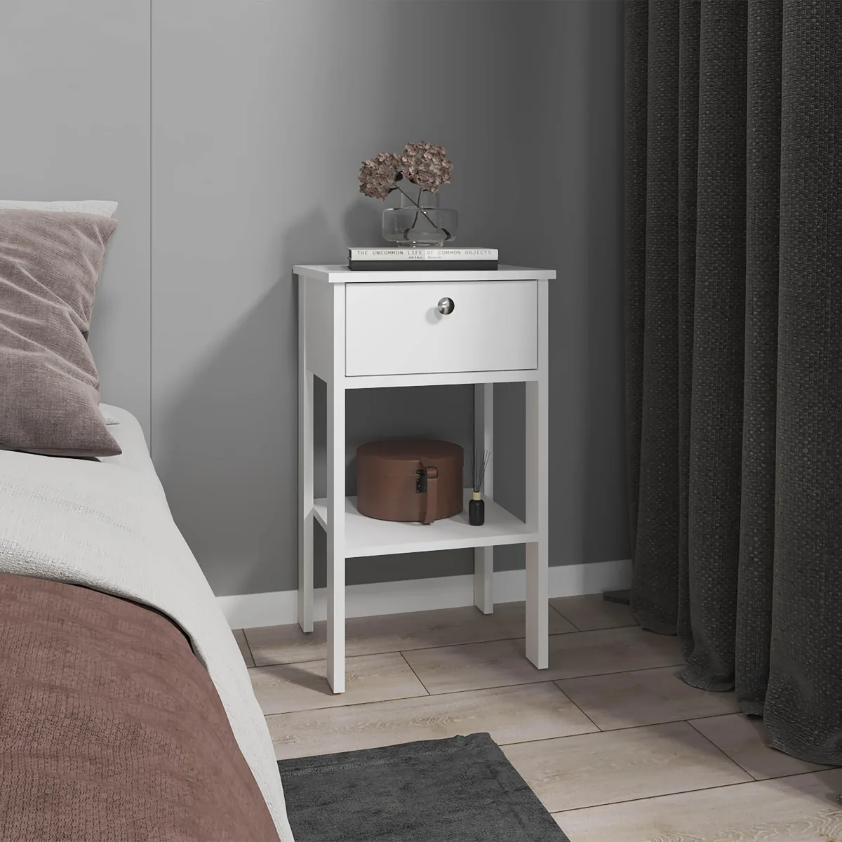 White nightstand with one drawer and open shelf on four legs