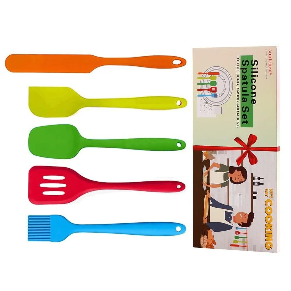 Five small silicone spatulas in orange, yellow, green, red and blue on a light background