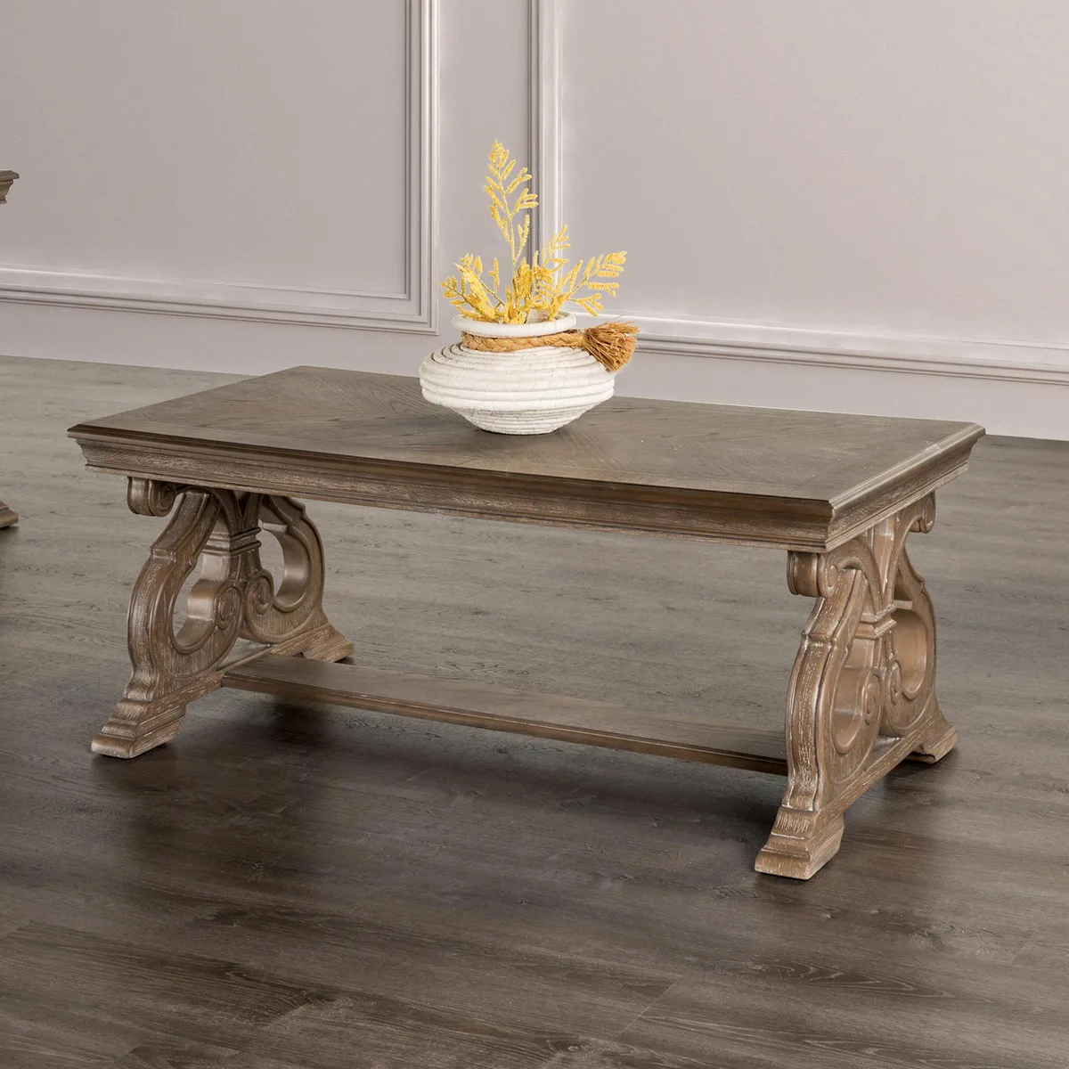 Rectangular coffee table with carved scroll legs in weathered oak finish