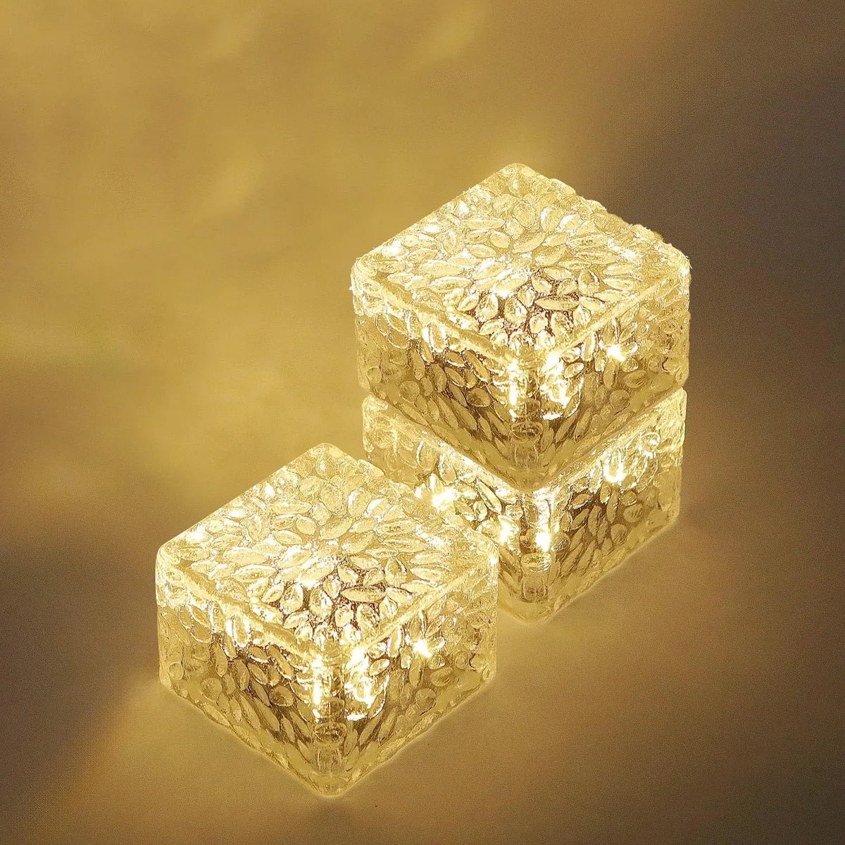 Three small square warm-white solar path lights in a pack