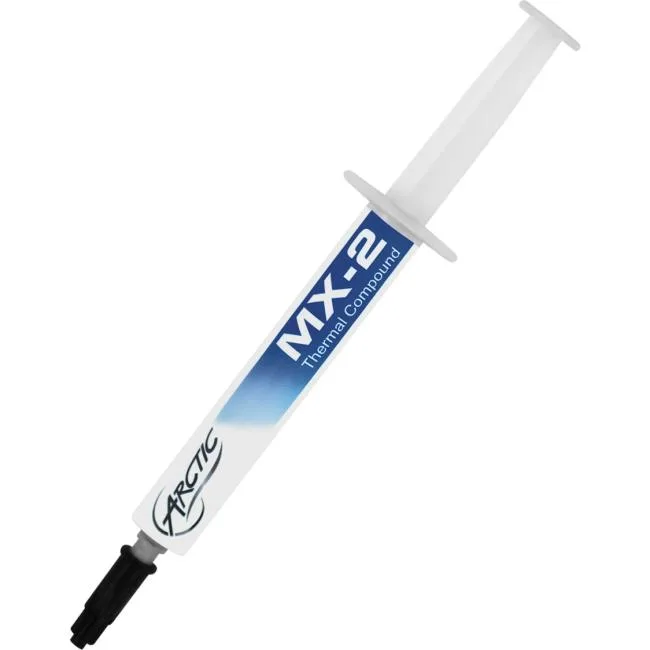 White syringe with grey plunger and green cap on grey surface