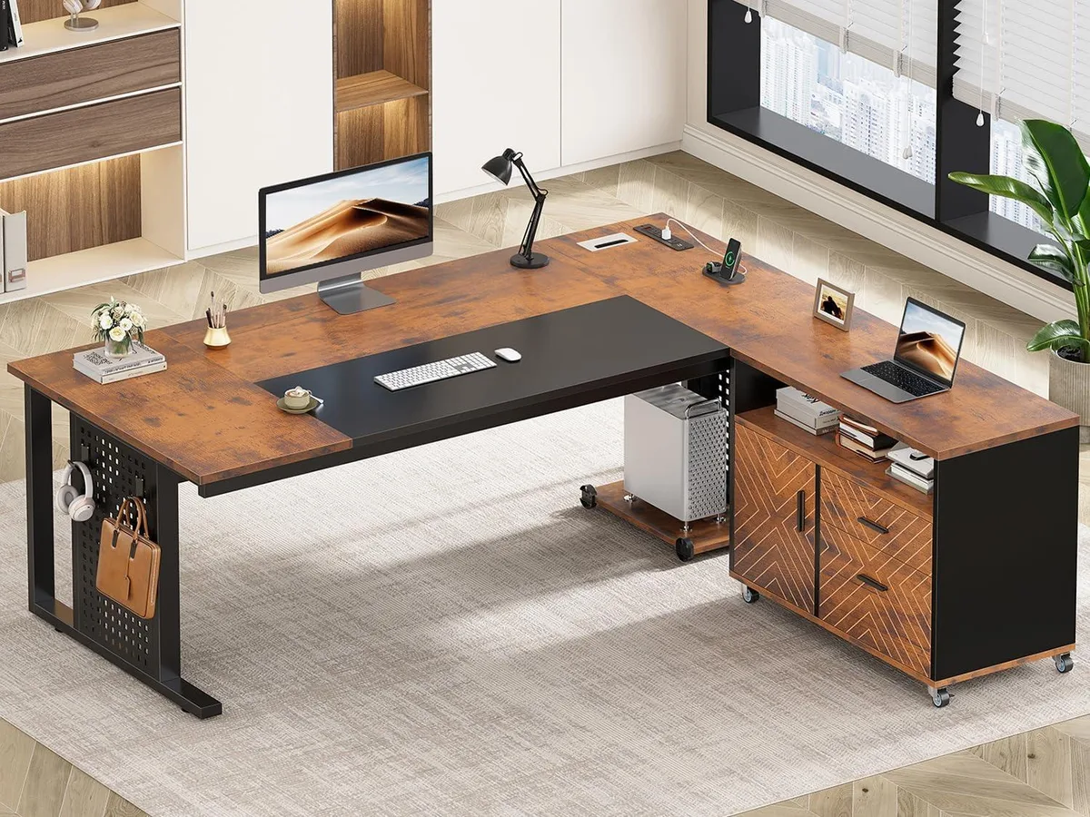 L-shaped desk with rolling cabinet, rustic brown finish, pegboard and shelves visible