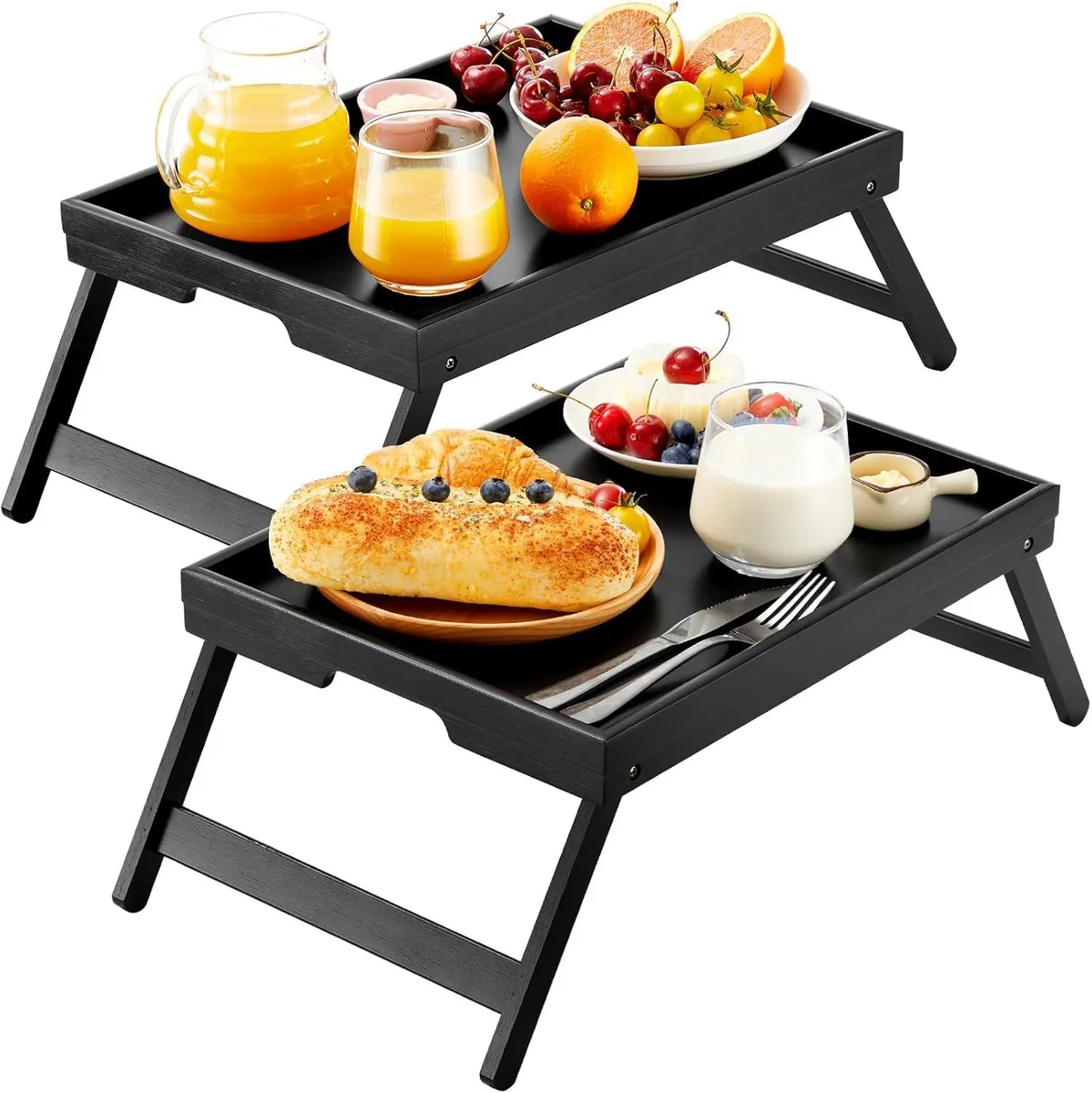 Two black bamboo bed trays with folded legs lying flat