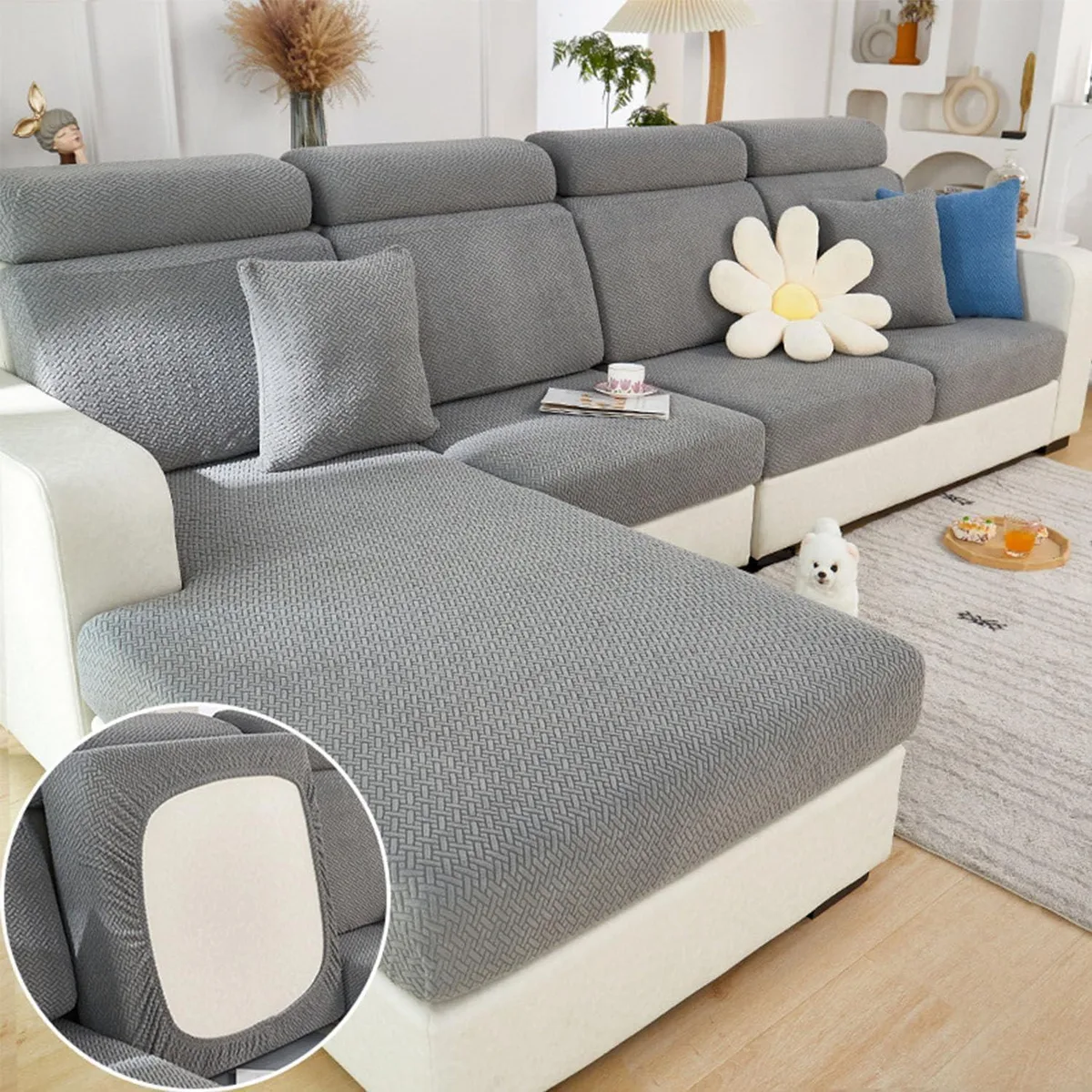 Gray stretch slipcover with elastic hem, folded flat showing textured polyester-spandex fabric