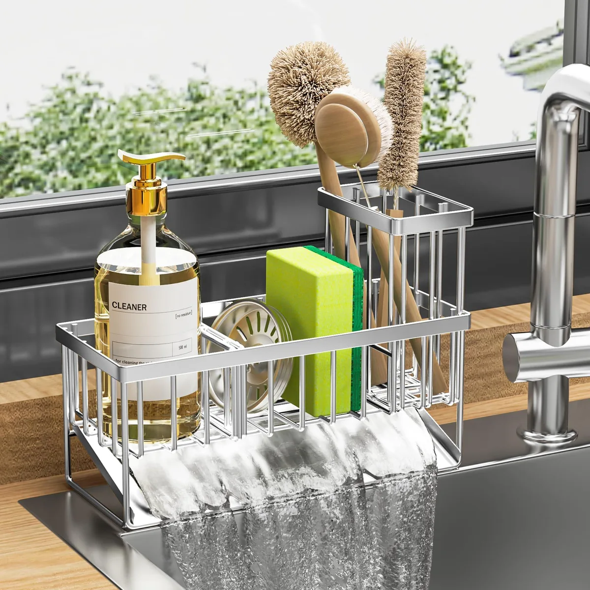 Silver stainless steel sink caddy with sloped drainage tray, divided compartments and tall brush holder