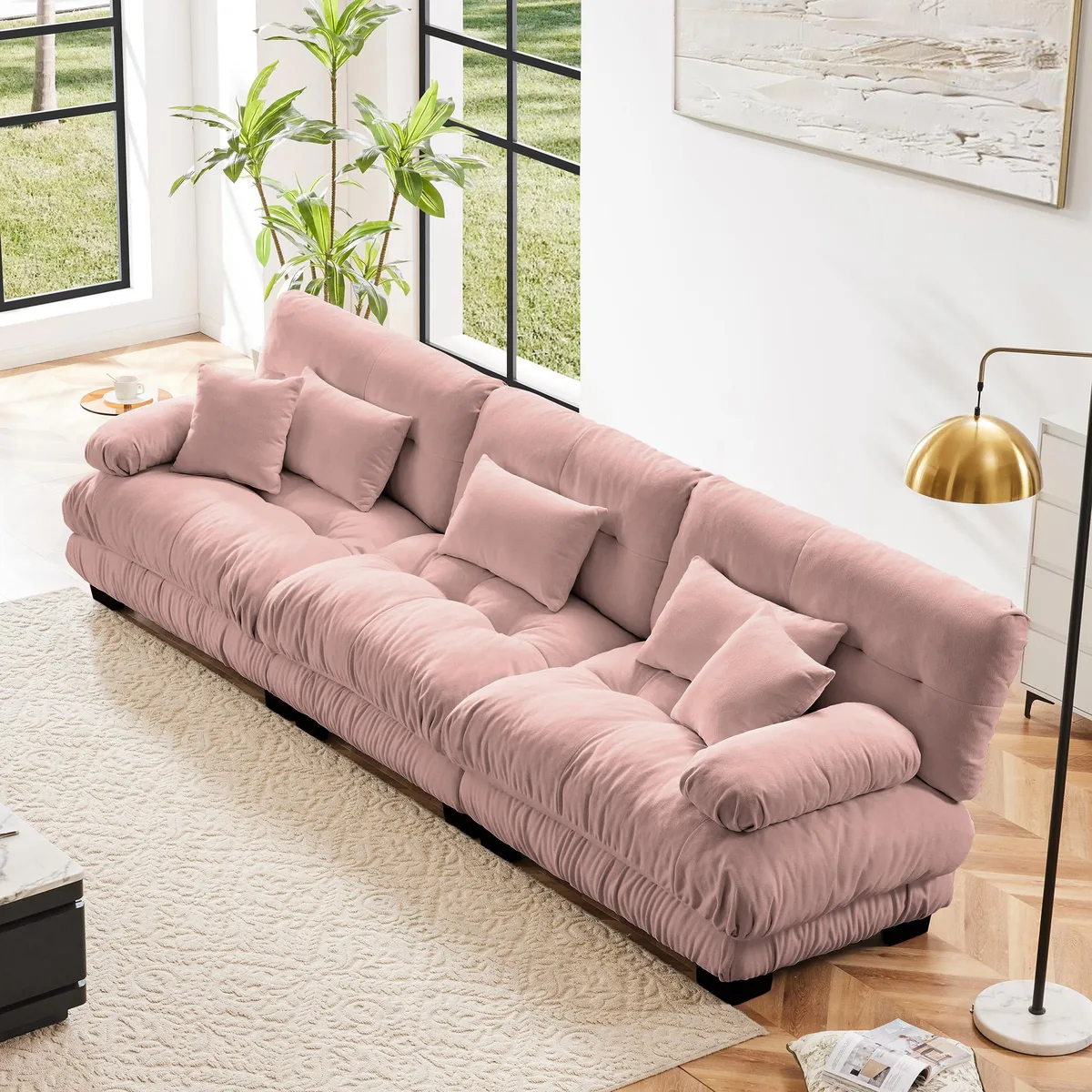 Pink chenille modular sectional sofa with rounded bolster armrests and deep seat cushions