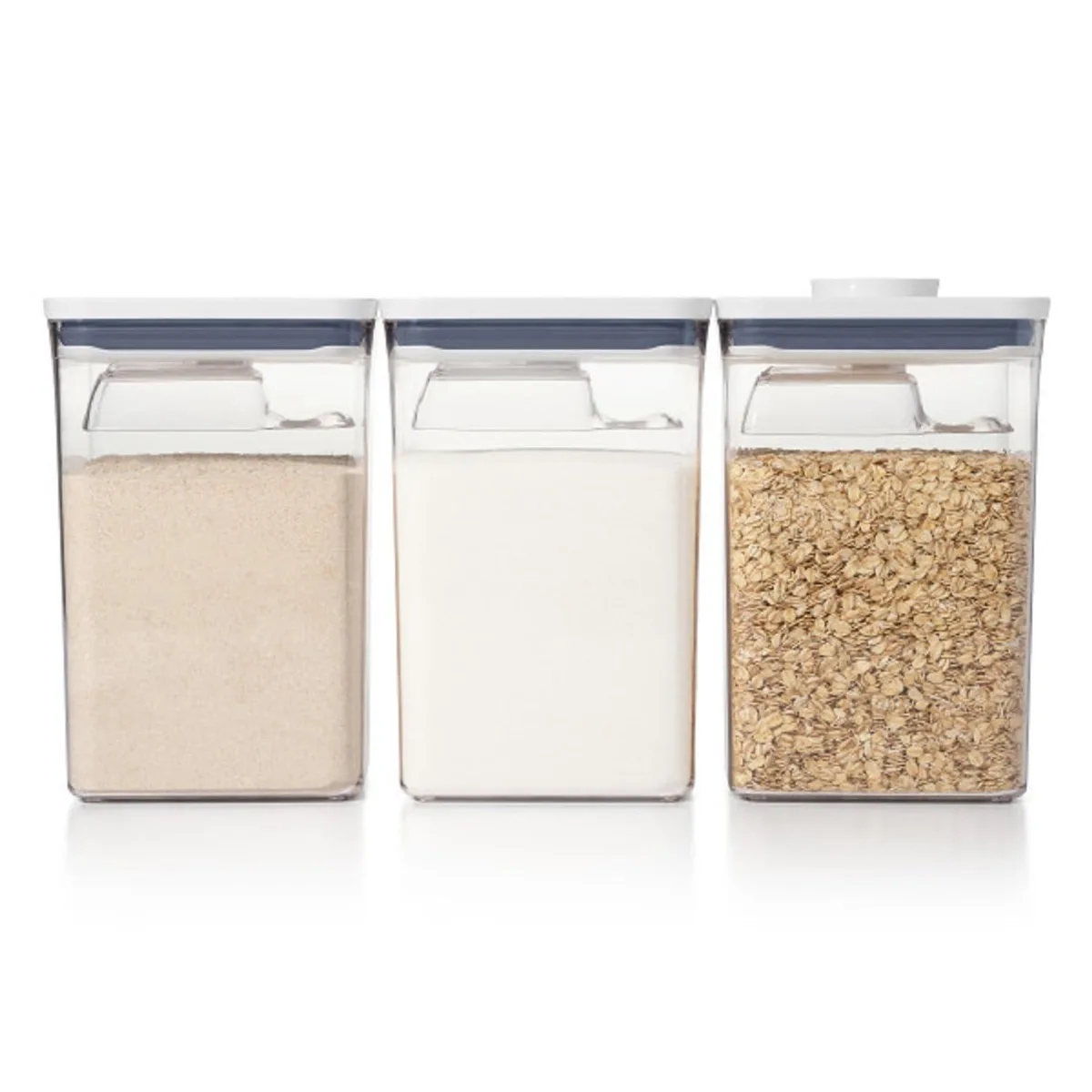 Six clear rectangular containers with red push-button lids and attached scoops, stacked together