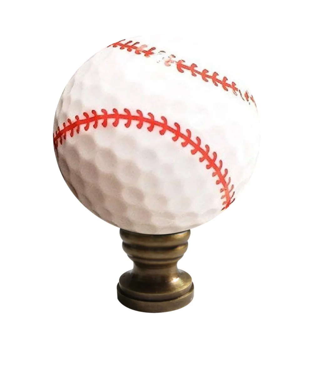 White baseball-shaped lamp finial with red stitching, antiqued brass finish, 2.25 inches tall