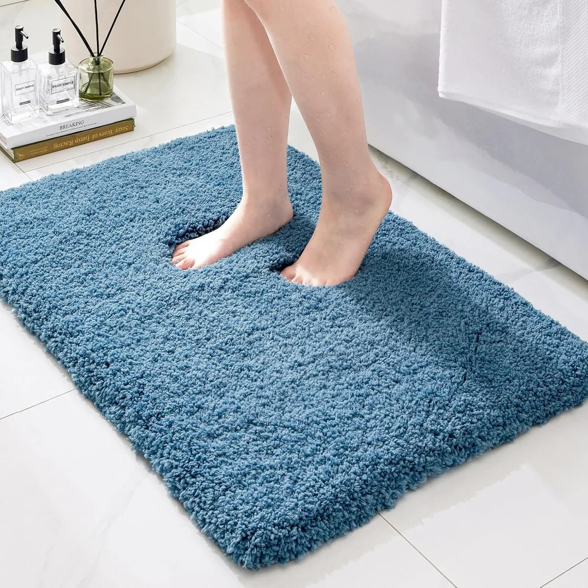 Blue rectangular bath mat 24 by 17 inches with plush shaggy pile and rubber backing
