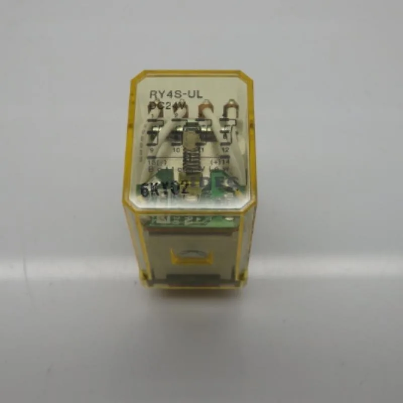 Small rectangular relay with silver pins and plastic housing