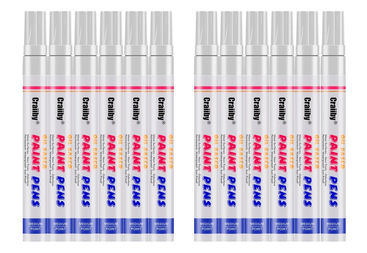 Twelve white oil-based paint marker pens with medium tips
