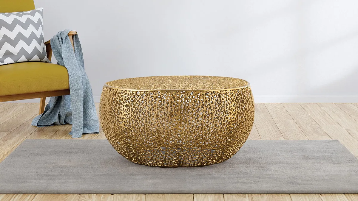 Round gold aluminium coffee table with cast frame
