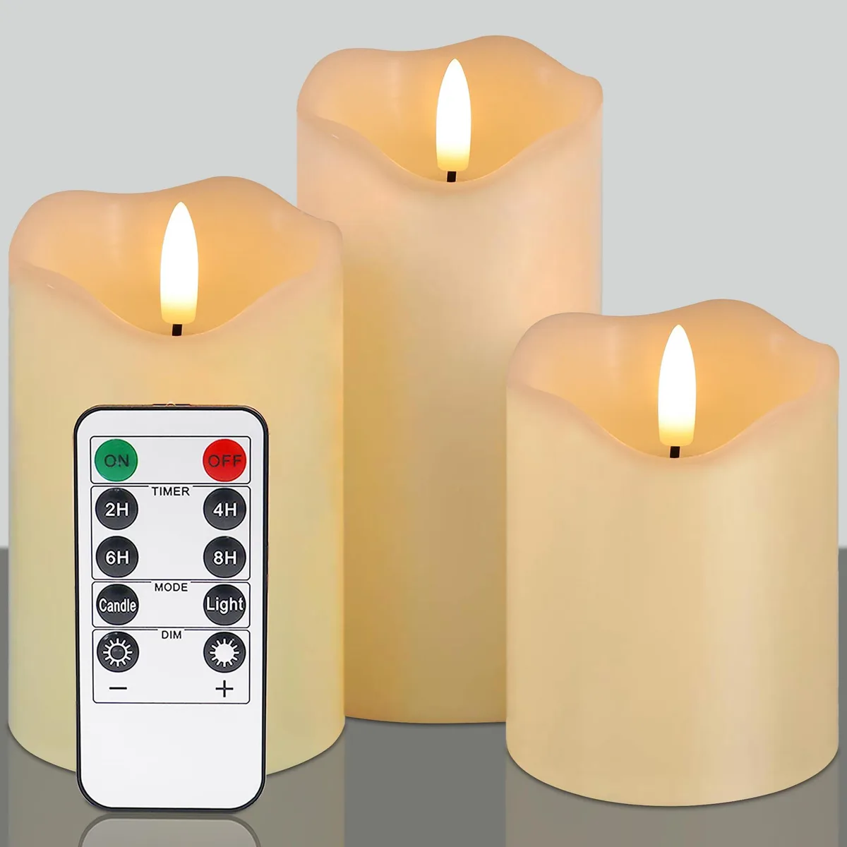 Three ivory wax pillar candles with remote control
