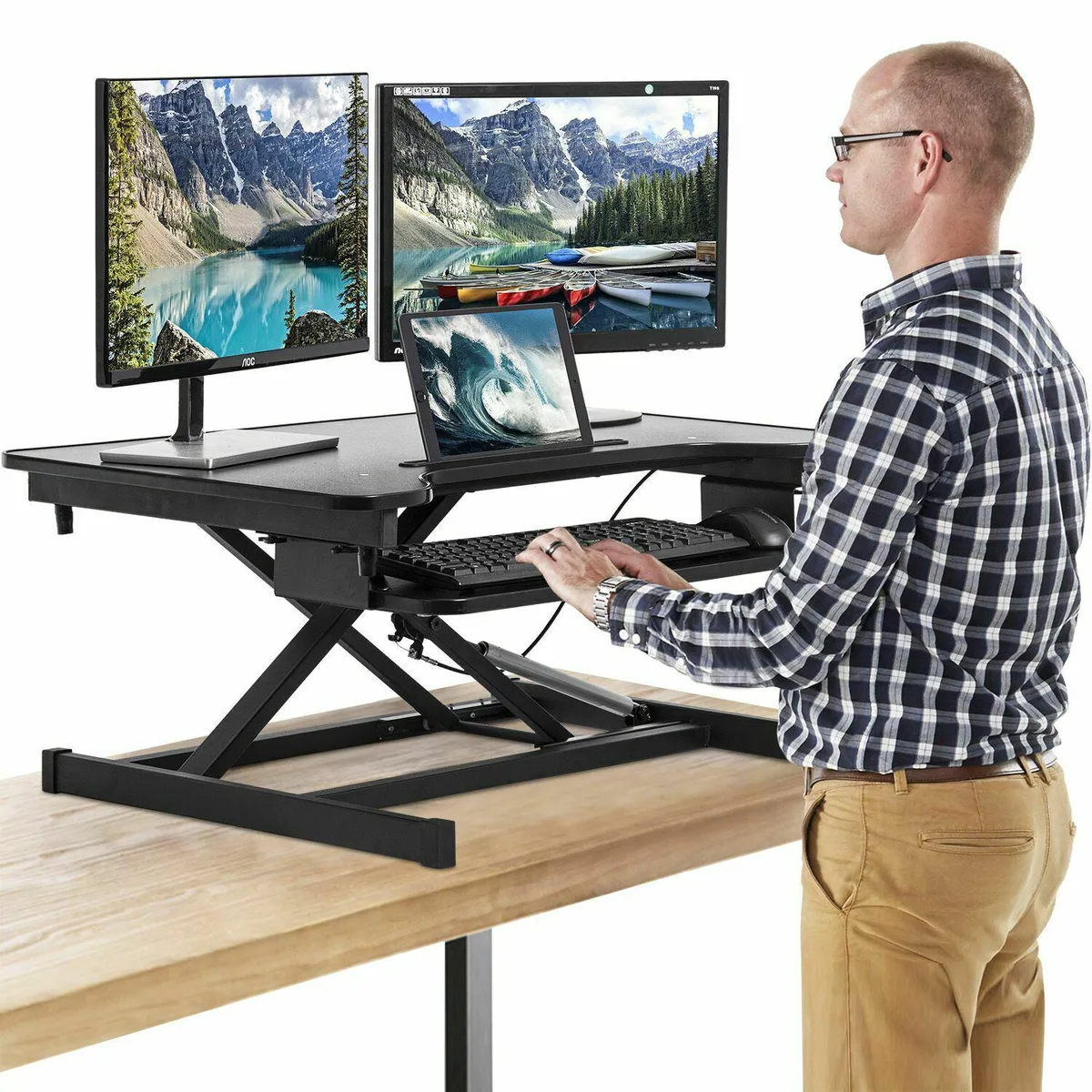 Black rectangular standing desk converter with two-tier surface and gas-spring lift mechanism