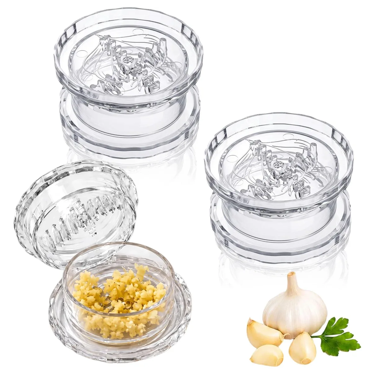 Three clear plastic garlic twisters with interlocking teeth, cylindrical shape, smooth finish