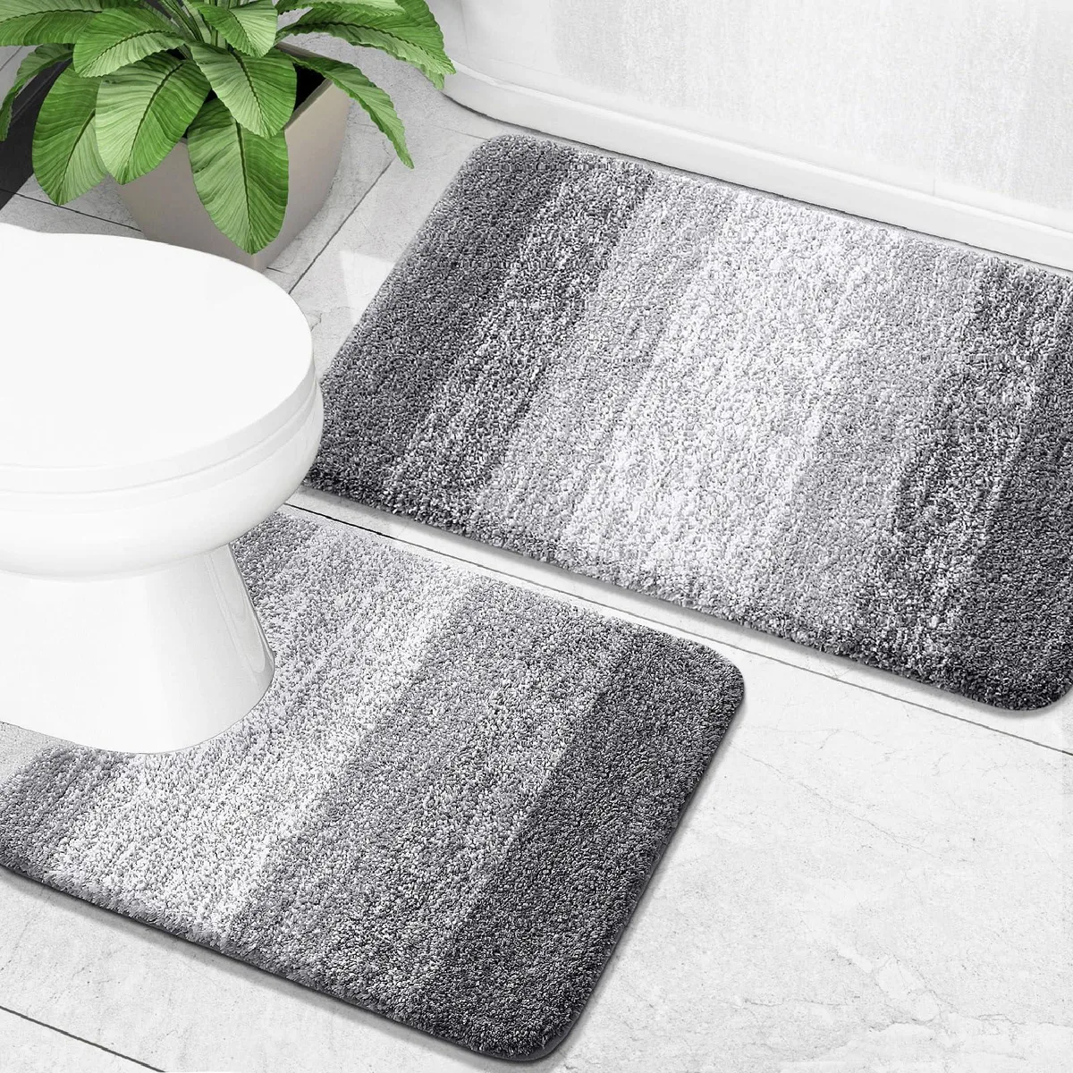 Two grey microfiber bath mats, rectangular and U-shaped, plush shaggy pile, rubber backing