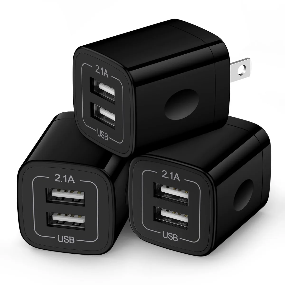 Three small black cube wall chargers each with two USB ports