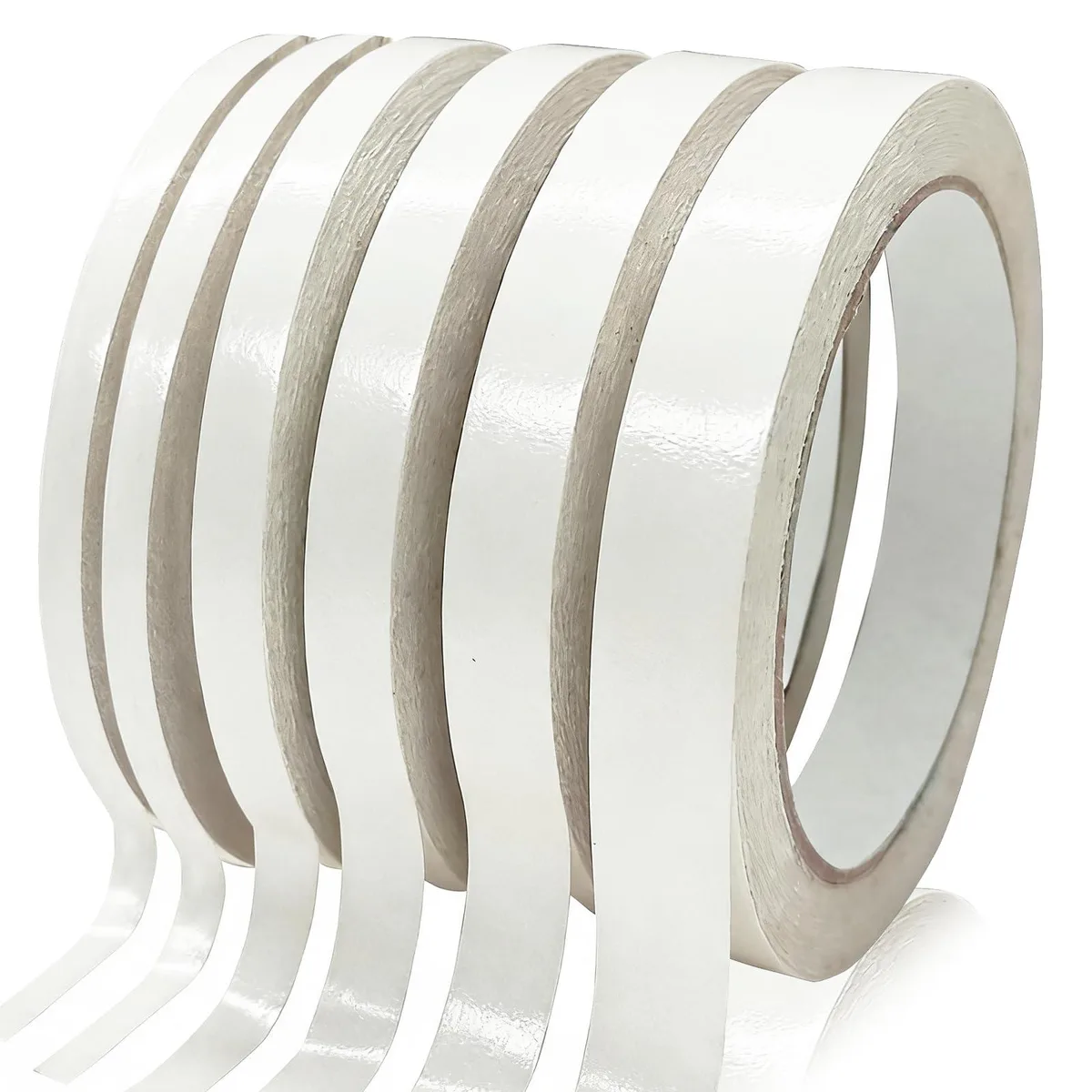 Six white double-sided tape rolls on a surface, widths from .12 to .59 in, each 65 ft long