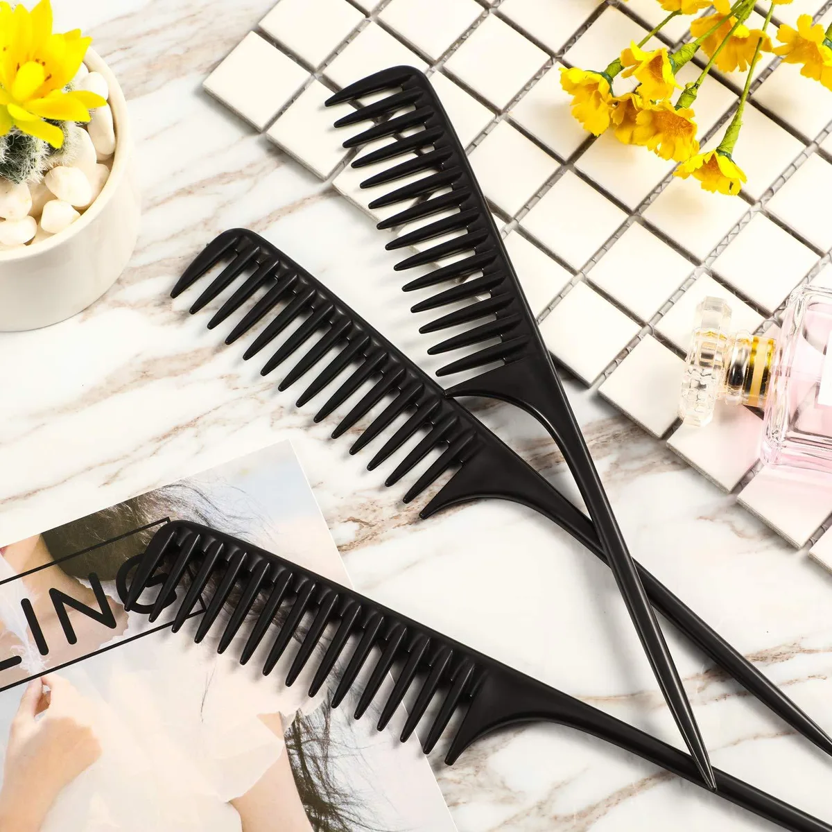 Three black carbon-fiber tail combs with stainless steel handles, wide teeth and serrated edges